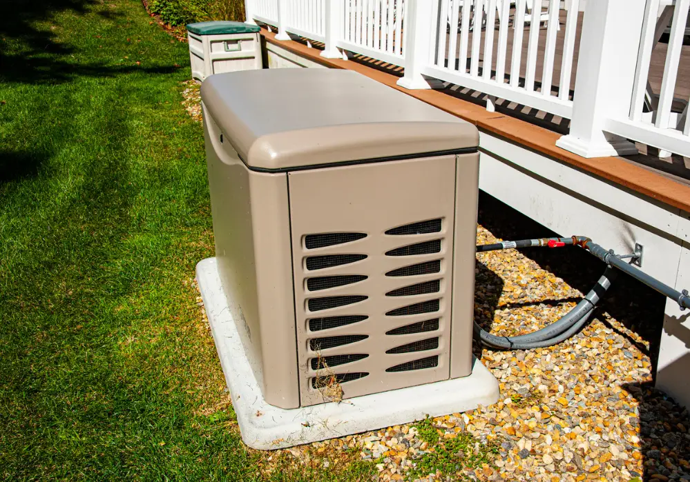 generator installed next to deck on green lawn